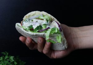 Köstliche, frische Falafeltasche, gehalten von einer Hand