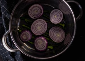 Die Röllchen werden auf Zwiebel und Strunken gekocht