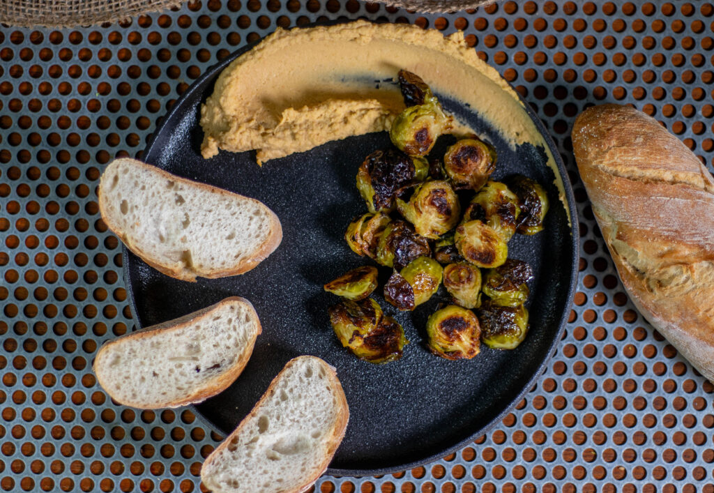 Rosenkohl aus dem Ofen ist eine tolle Beilage, aber er schmeckt auch als Snack sehr gut, wie hier mit Hummus und Brot.