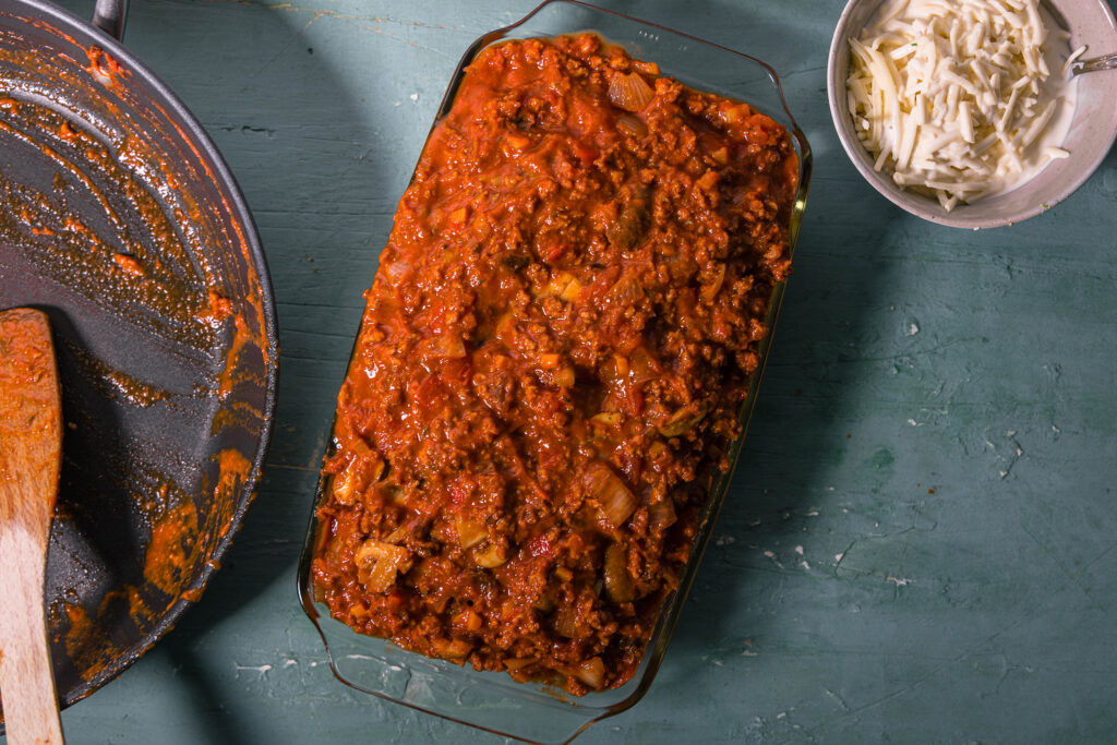 7. Dann kommt die restliche Bolognese über die Cannelloni. Diese müssen gut bedeckt sein, damit sie im Ofen nicht austrocknen.