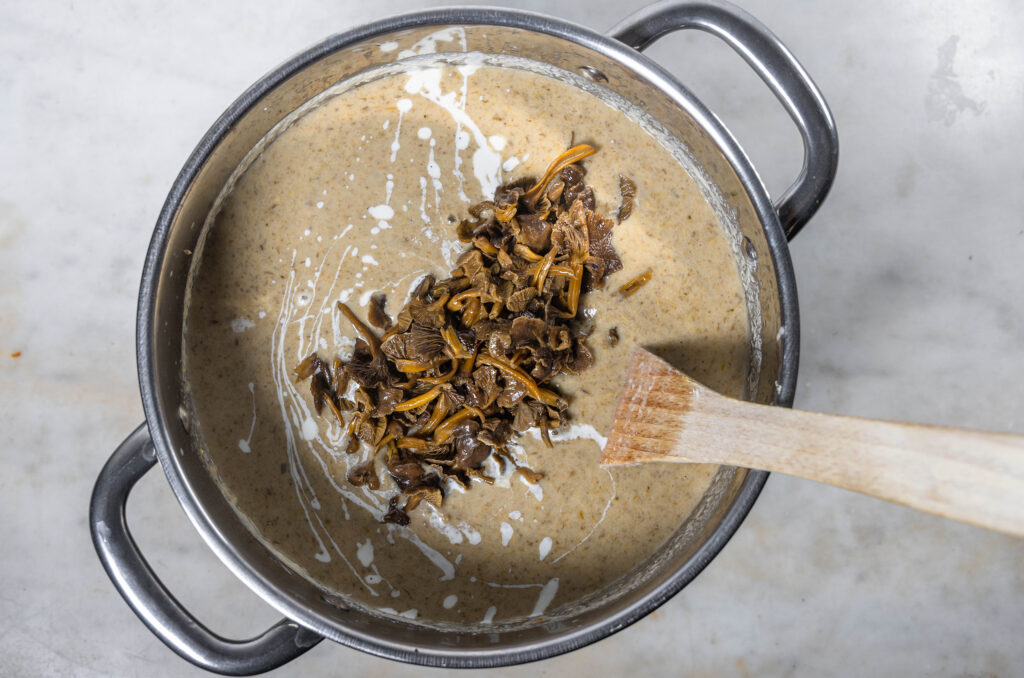 8. Dann die restlichen Pilze und die vegane Sahne zugeben. Und die Suppe mit Salz und Pfeffer abschmecken.